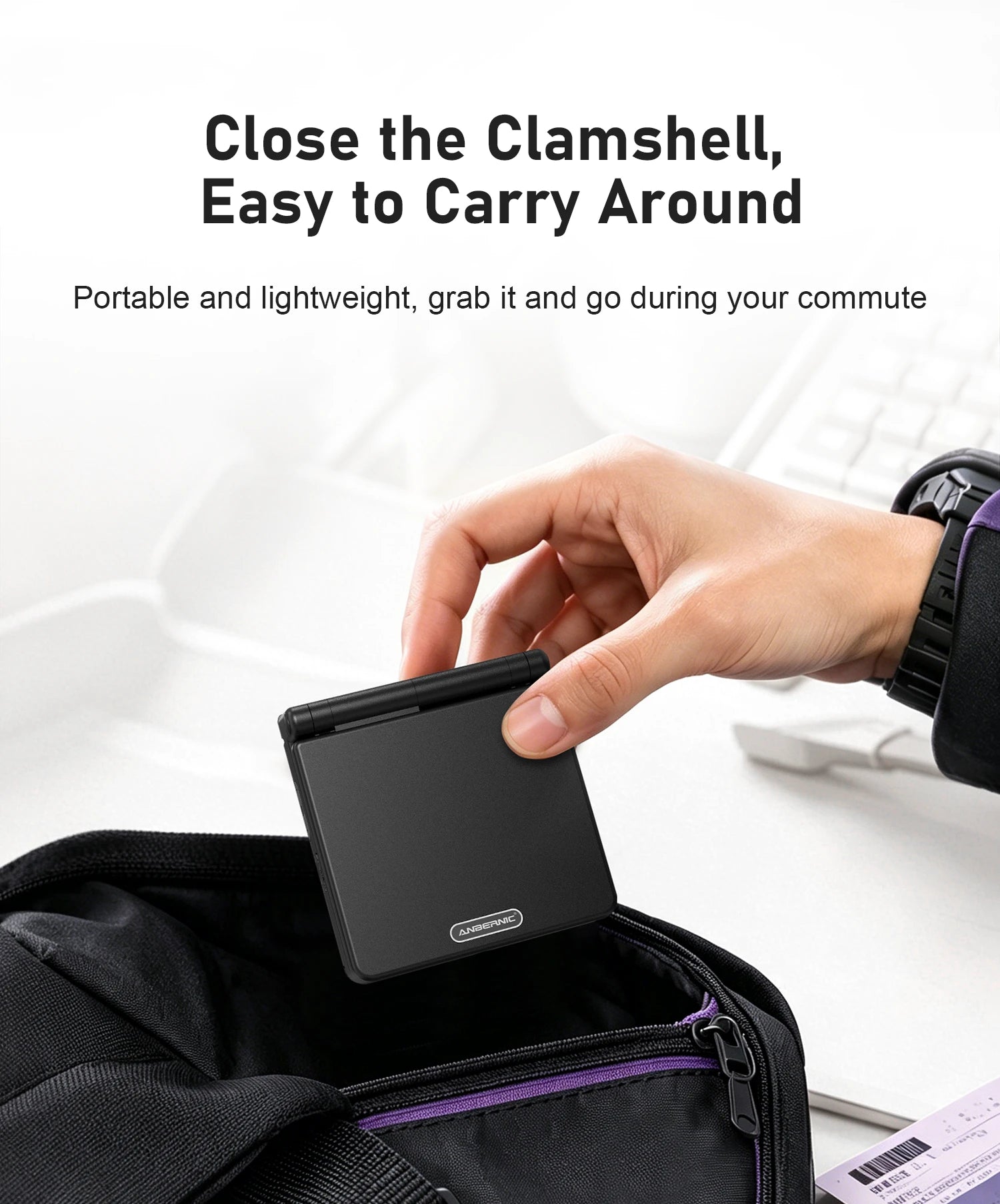 Hand placing a closed black ANBERNIC clamshell handheld into a zippered bag, with portability text